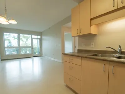 Kitchen with view to living room and balcony