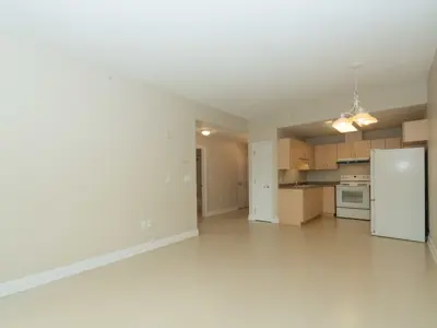 View of living room and kitchen towards hallway