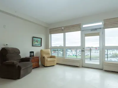 Sitting area with easy chairs beside large window